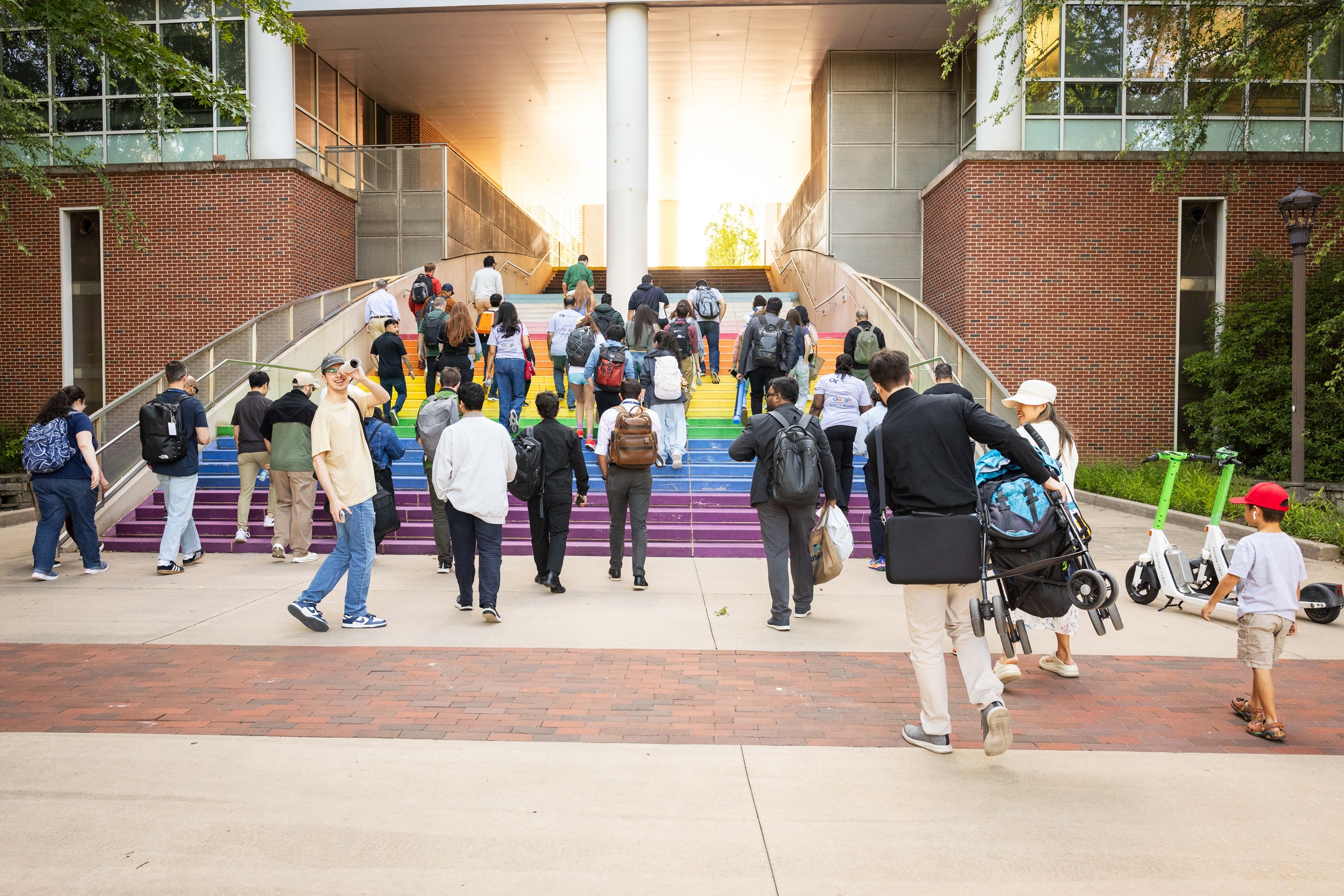 Attendees walking up rainbow steps of Klaus