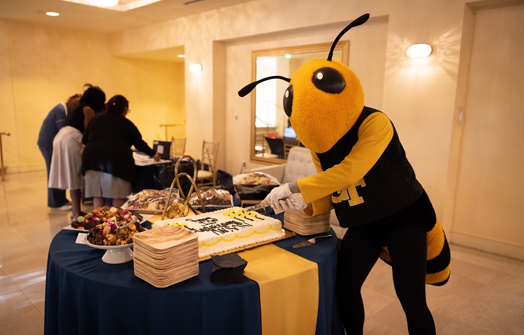 Buzz cutting the 10th anniversary cake