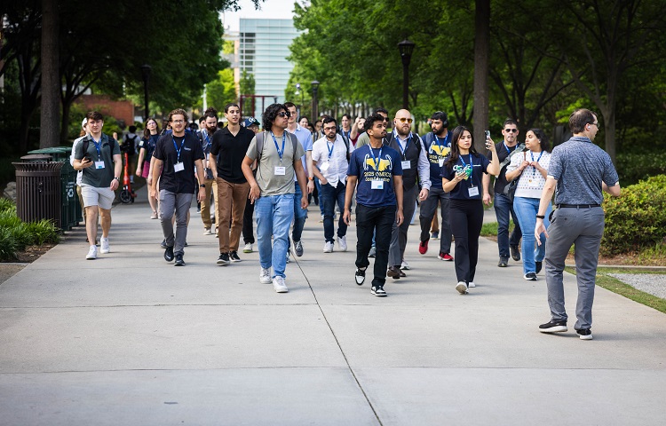 David Joyner walking backwards leading attendees on campus tour