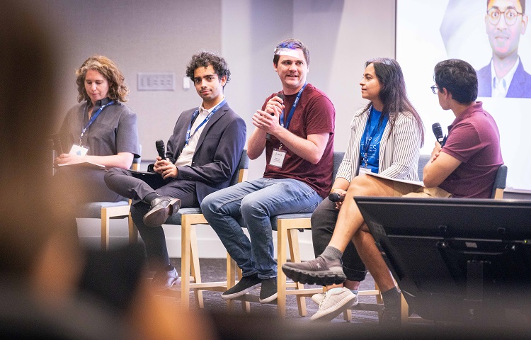 4 panelists and a moderator on stage