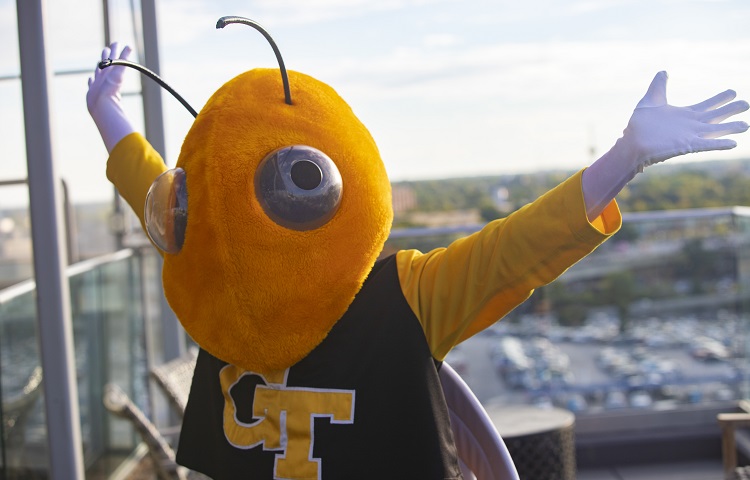 Buzz outside on a balcony with arms outstretched