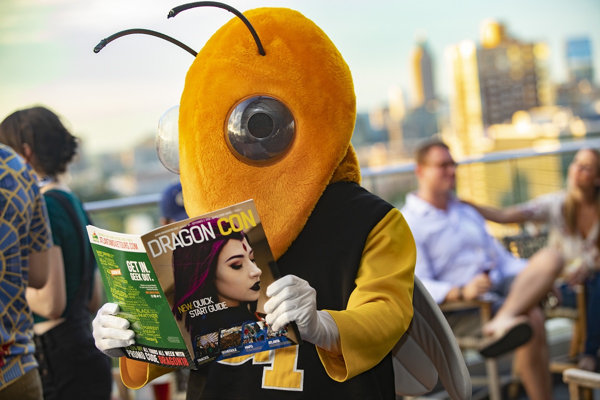 Buzz reading a DragonCon magazine