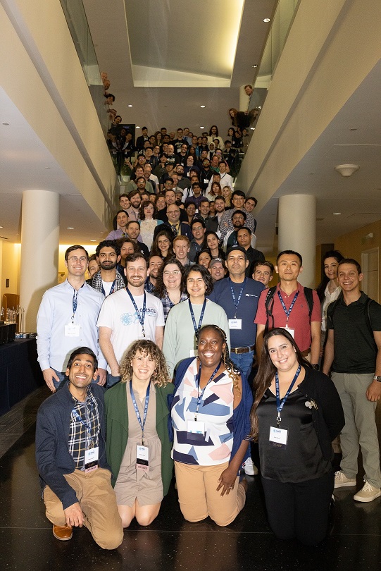 Group photo of all conference attendees on a staircase