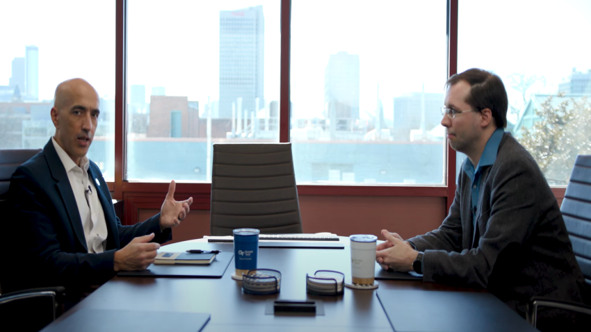 Alex Orso and David Joyner sitting at a conference table in conversation