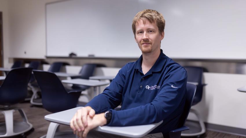 Ronnie Howard sitting at a desk in a classroom