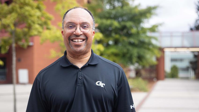 Mark Moss in a Georgia Tech polo standing outside the College of Computing building