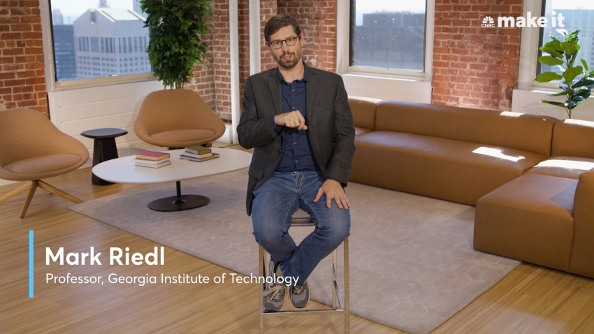 Mark Riedl sitting in a chair talking to the camera