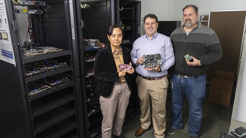Hyesoon Kim, Jeff Young, and Will Powell holding items from the Rogues Gallery