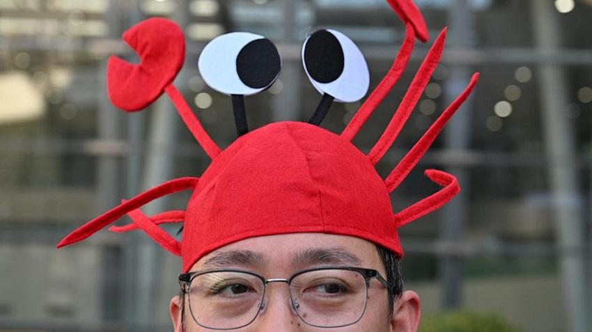A man wears a lobster hat that represents the OpenClaw logo, an open-source AI assistant at the Baidu headquarters in Beijing