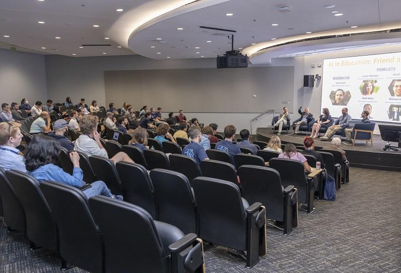 Wide shot of the audience and panelists during a panel at the 2024 OMSCS Conference