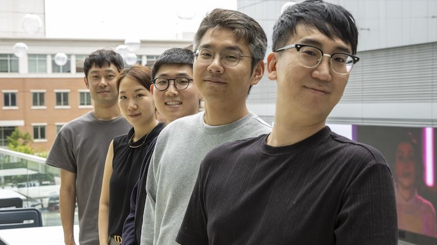 5 researchers standing in a line