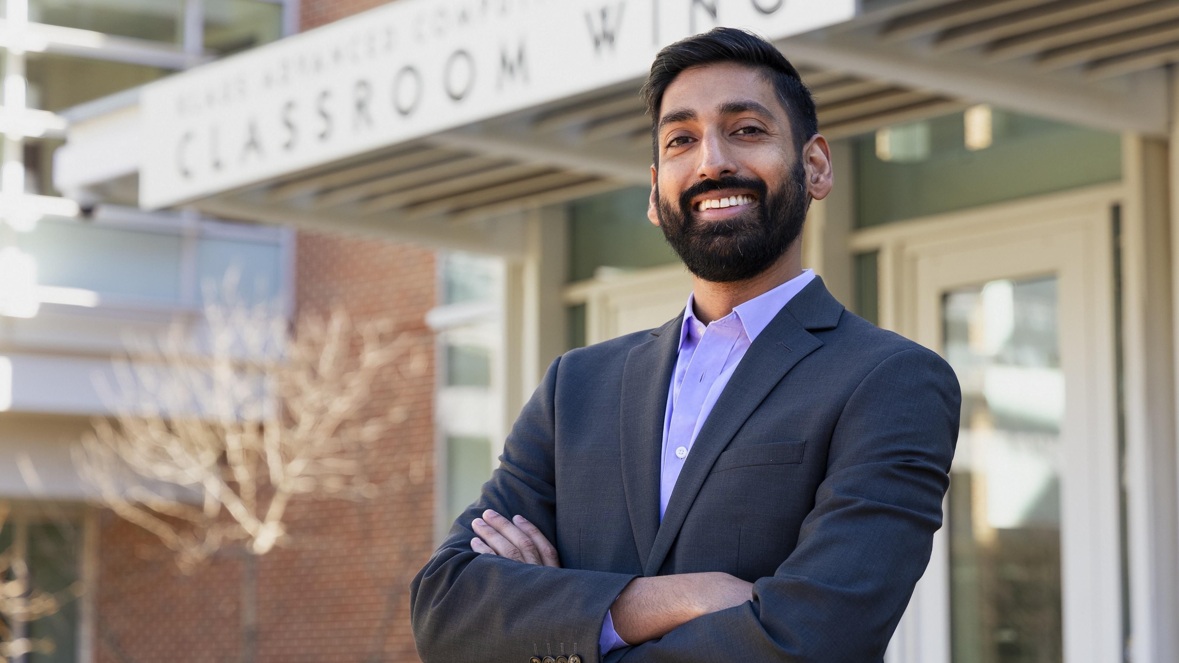 Alex Duncan standing outside the Klaus classroom building