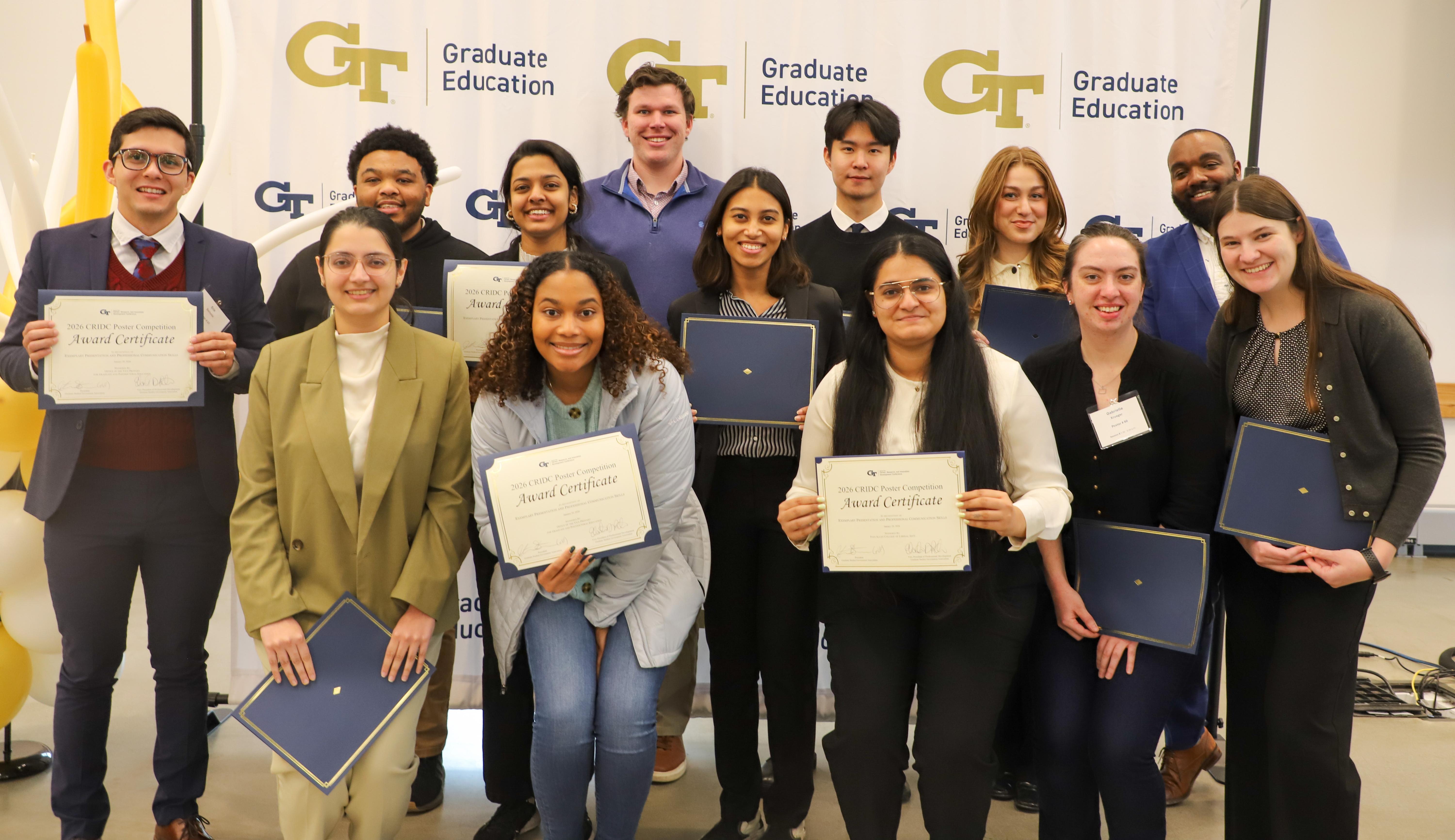A group of people posing for a picture holding their award certificates